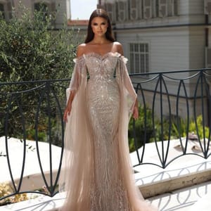 Luxury Champagne Crystal Embellished Off-Shoulder Evening Gown with Sheer Cape Sleeves from Luxoroa