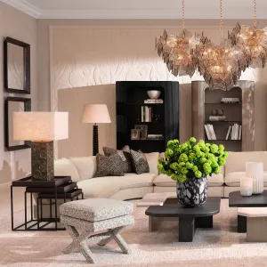 Taburete otomano de tela estampada en color beige con asiento acolchado y base en forma de cruz - Mobiliario de lujo para hoteles Vista lifestyle por Luxury Group International