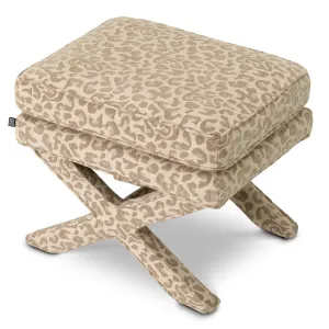 Taburete otomano de tela estampada en color beige con asiento acolchado y base en forma de cruz - Mobiliario de lujo para hoteles Vista superior por Luxury Group International