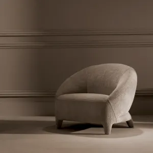 Beige Textured Fabric Lounge Chair with Curved Backrest and Sculptural Legs - Luxury Hotel Furniture Lifestyle View by Luxury Group International