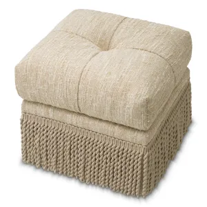 Taburete otomano de tela con textura cremosa, base con flecos y cojín mullido - Taburete de lujo Vista frontal por Luxury Group International