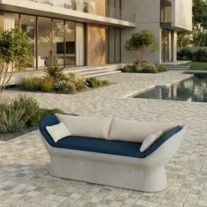 Grey Luxury Concrete Sofa with Blue Cushions and Curved Armrests - Outdoor Furniture Lifestyle View by Luxury Group International