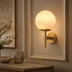 Luxury Alabaster Globe Wall Lamp with Brushed Brass Finish Lifestyle View by Luxury Group International