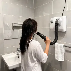Luxury Anti-Vandal Stainless Steel Hotel Hair Dryer with Flexible Hose Lifestyle View by Luxury Group International