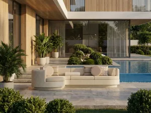 Luxury Contemporary Beige L-Shaped Sofa with Curved Chaise and Cream Cushions - Outdoor Furniture Lifestyle View by Luxury Group International