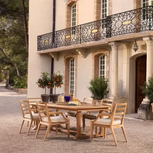 Luxury Natural Wood Outdoor Dining Armchair with White Seat Cushion and Slatted Backrest Lifestyle View by Luxury Group International