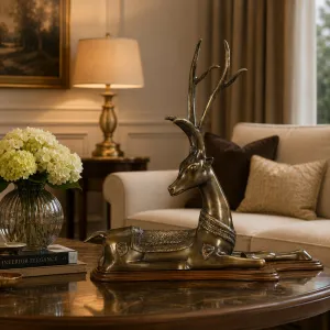 Luxury Reclining Antelope Bronze Sculpture on Wooden Base Lifestyle View by Luxury Group International