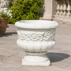 Luxury Round Garden Planter with Sculpted Floral Relief and Pedestal Base Lifestyle View by Luxury Group International