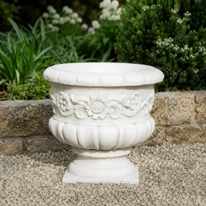 Luxury Round Garden Planter with Sculpted Floral Relief and Pedestal Base Lifestyle View by Luxury Group International