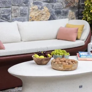 Ruby Red Luxury Concrete Sofa with Curved Arms and Terracotta Cushions - Luxury Hotel Furniture Lifestyle View by Luxury Group International