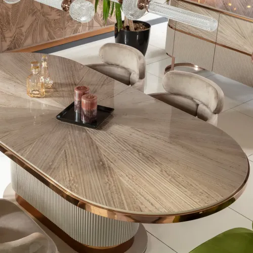 Beige oval oak wood luxury modern dining table with rose gold metallic accents by Luxury Group International