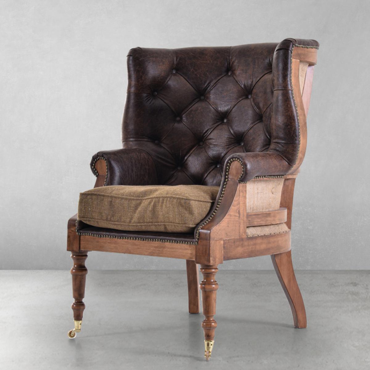 Luxury Tufted Leather Armchair with Open-Back Wooden Frame & Brass Castor Legs Front View by Luxury Group International