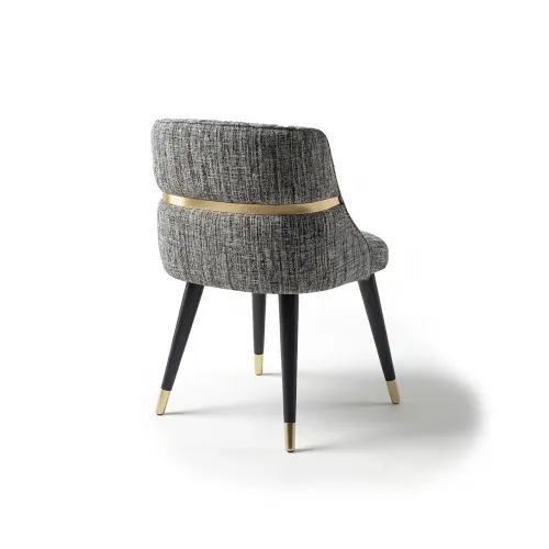 Gray upholstered luxury dining chair with black leg & golden detailing by Luxury Group International