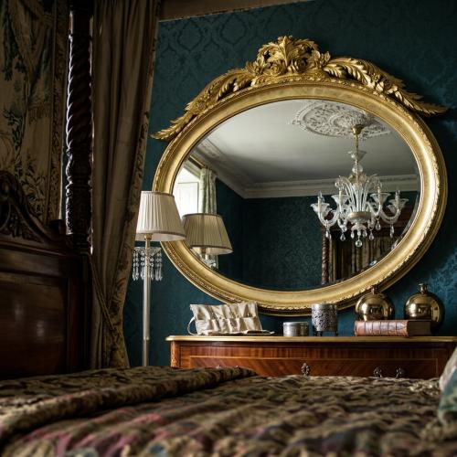 Luxury Gold Oval Baroque Wall Mirror with Grand Floral Leaf Crest - Baroque Mirror Lifestyle View by Luxury Group International