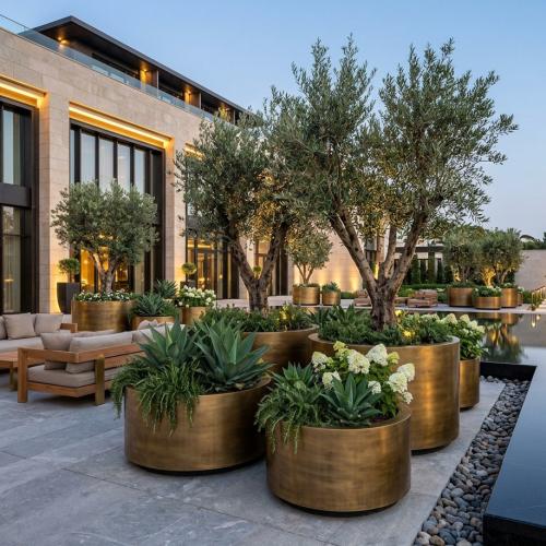 Luxury Grand Cylindrical Planter Pot in Gold & Weathered Brass Finish - Ø 170 cm Lifestyle View by Luxury Group International
