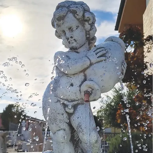 Luxury Illuminated Baroque Cherub Water Fountain with Circular Sculpted Basin & Pedestal Base - Baroque Fountain Detail View by Luxury Group International