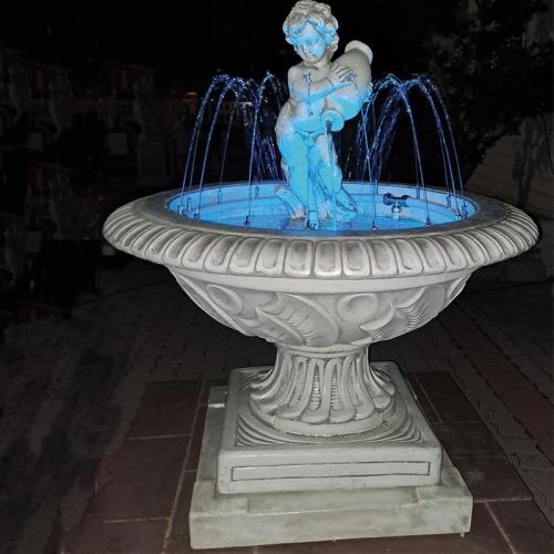 Luxury Illuminated Baroque Cherub Water Fountain with Circular Sculpted Basin & Pedestal Base - Baroque Fountain Front View by Luxury Group International