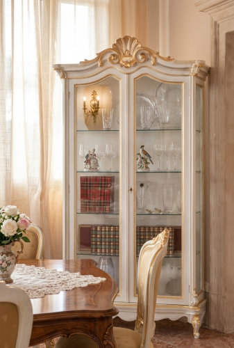 Luxury Ivory Baroque Double Door Glass Display Cabinet with Sculpted Crown Crest & Golden Trim Accents Lifestyle View by Luxury Group International