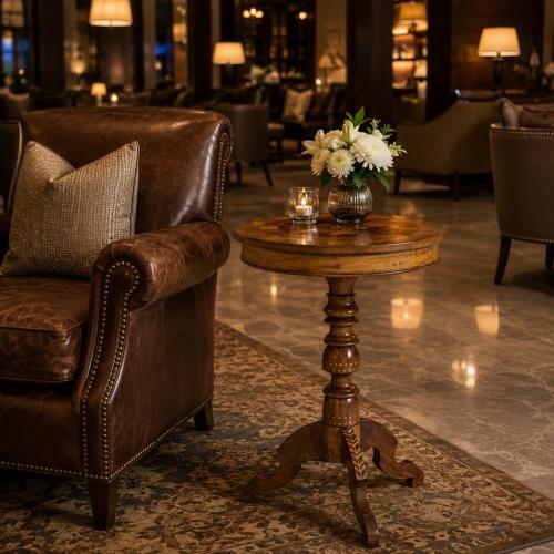 Luxury Round Wooden Side Table with Marquetry Inlay Top and Sculpted Pedestal Base Lifestyle View by Luxury Group International