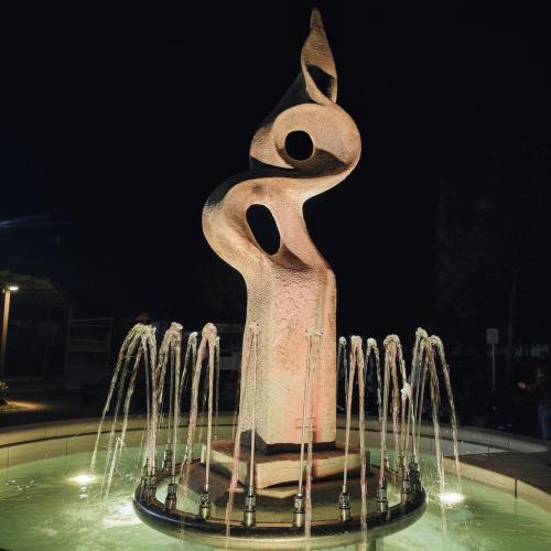 Luxury Sculptural Illuminated Water Fountain in Abstract Form with Circular Basin - Baroque Fountain Lifestyle View by Luxury Group International