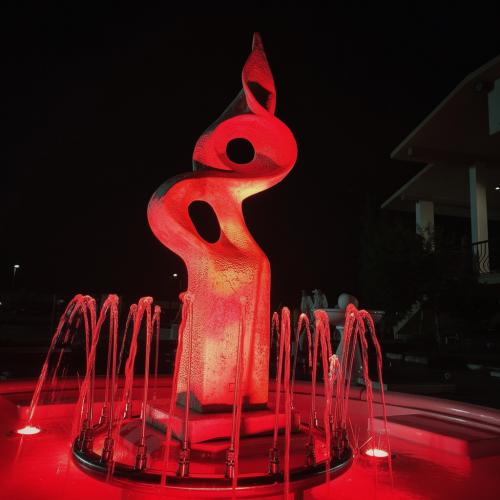 Luxury Sculptural Illuminated Water Fountain in Abstract Form with Circular Basin - Baroque Fountain Lifestyle View by Luxury Group International