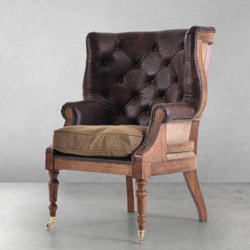 Luxury Tufted Leather Armchair with Open-Back Wooden Frame & Brass Castor Legs Front View by Luxury Group International